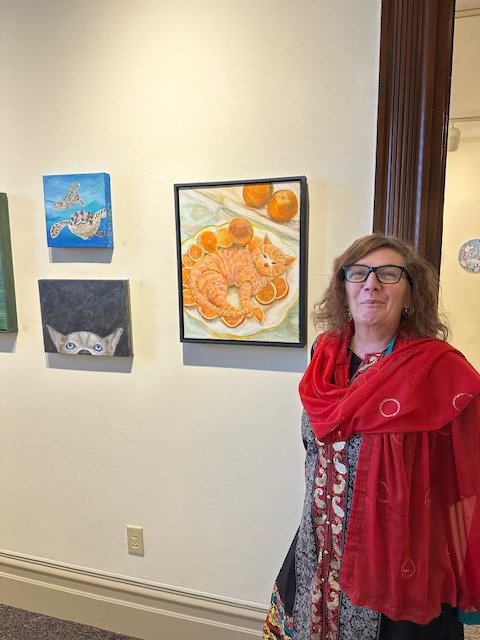 Carolyn near artwork in a gallery
